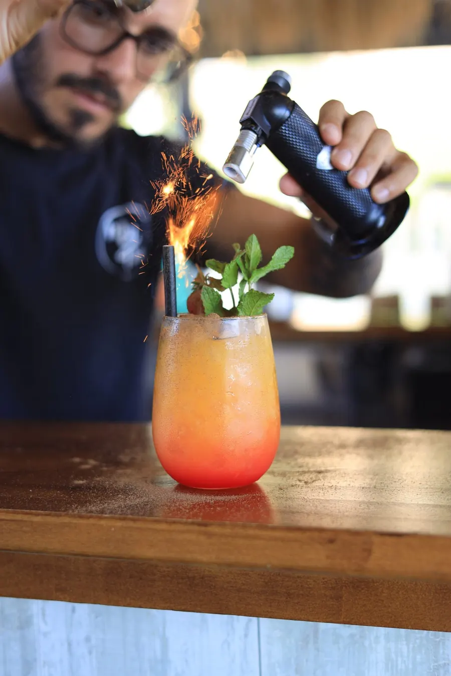 A cocktail being finished at the bar