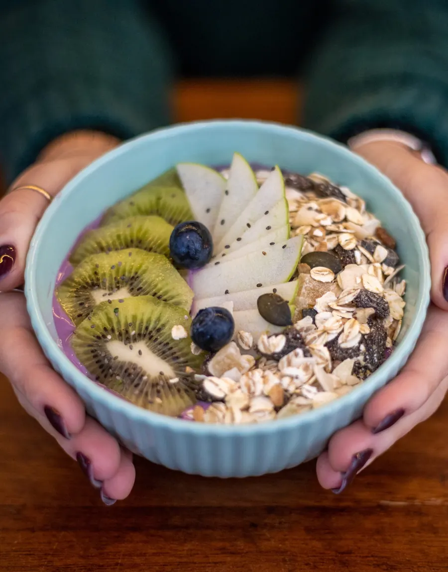 Fresh fruit bowl with yogurt, kiwi, blueberries and muesli