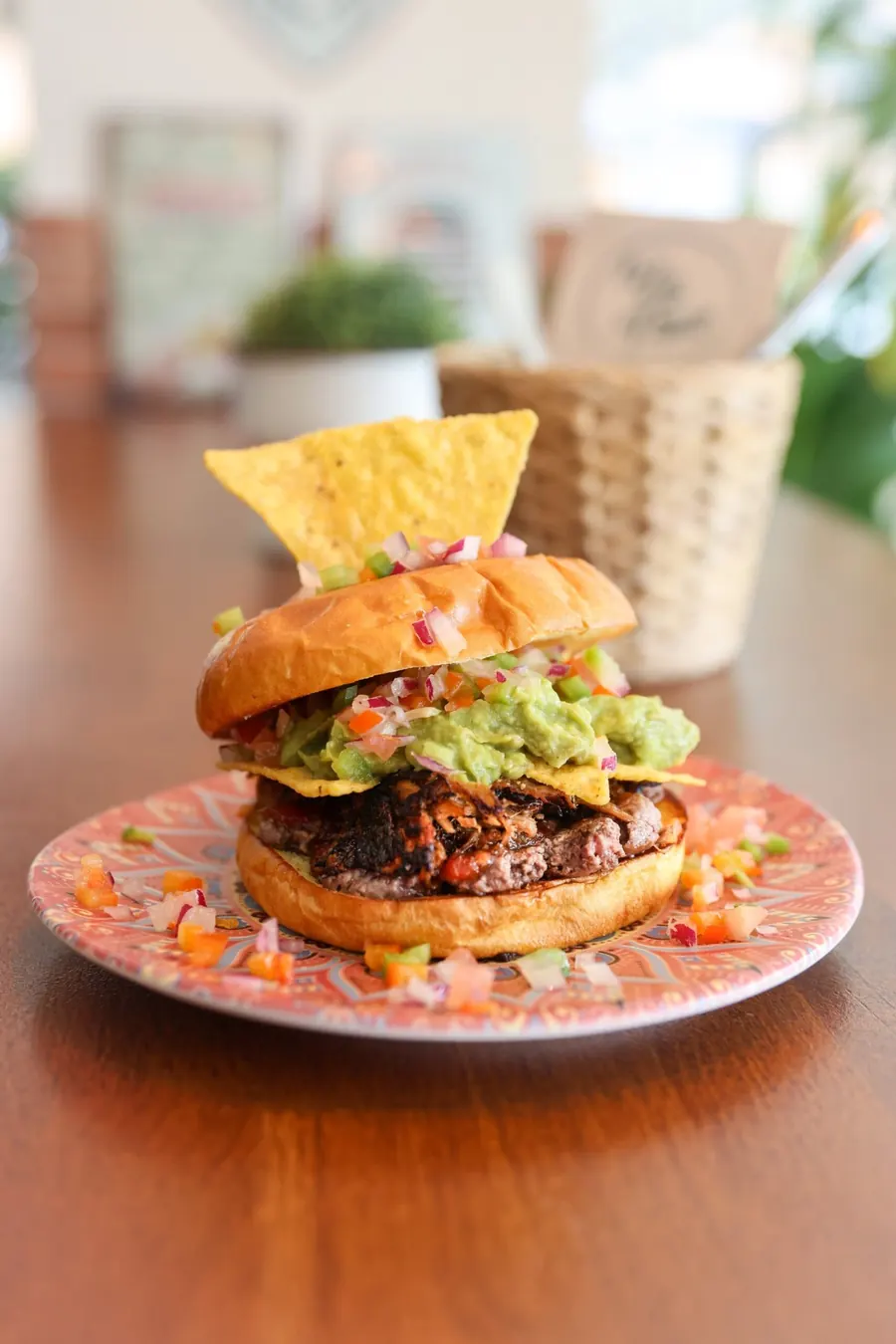 Burger topped with nachos and guacamole