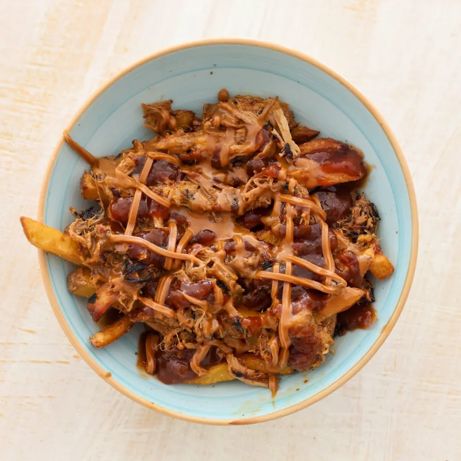 Loaded fries with melted cheese and pulled pork