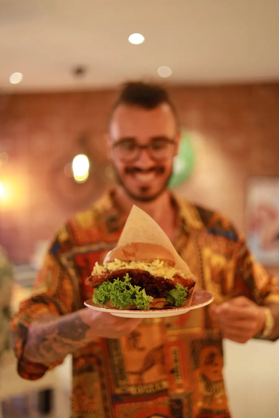 A waiter holding a burger